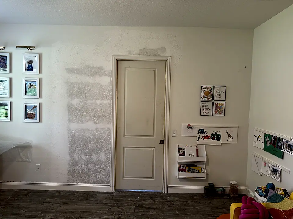 Drywall patch mudded and ready for texture beside the door