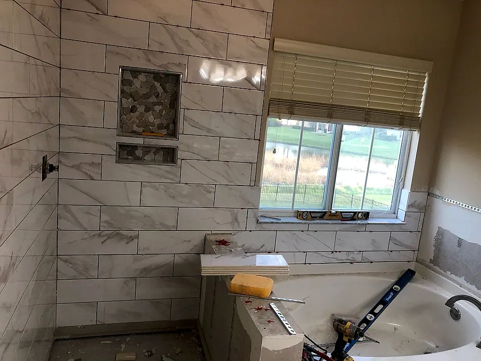 Primary bath mid-renovation, wall tile set and the tub surround still under construction
